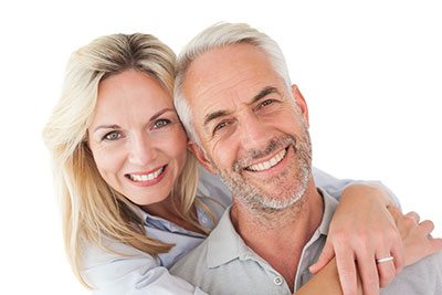 elderly couple smiling after dental restoration in vancouver